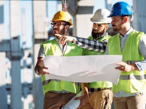 Portrait of construction engineers working on building site